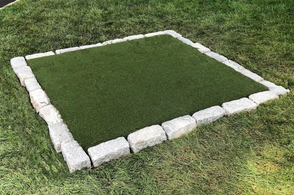 Austin Tee box made of synthetic grass surrounded by stone border